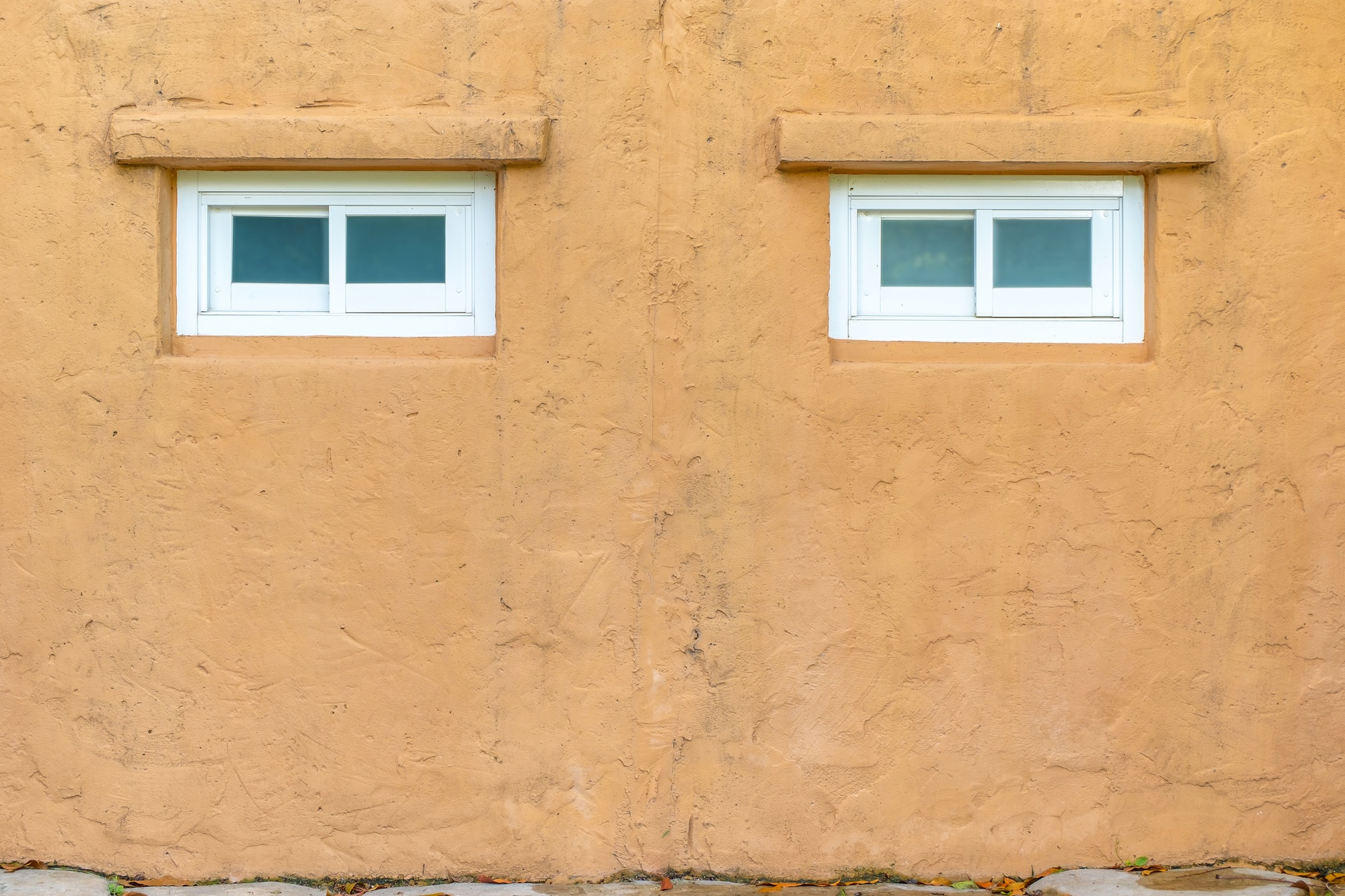 Stucco orange wall with white window texture background