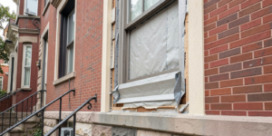Window-to-Stucco Transition Flashing Failures in Philadelphia Rowhomes shown in a realistic Philadelphia, PA residential construction setting.